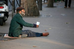 homeless man sitting on the street