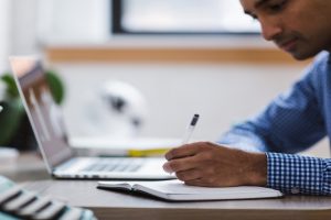 university student studying by laptop