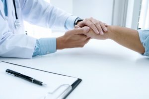 doctor supporting patient in clinic