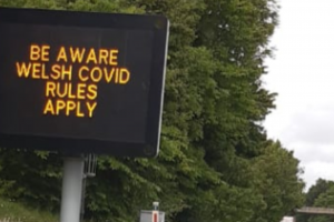 Sign on the A55 near Queensferry at border between Wales and England