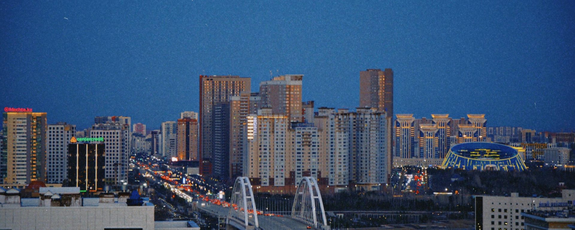 Astana Skyline at Night with an Illuminated Bridge