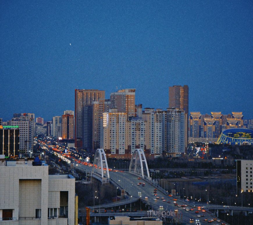Astana Skyline at Night with an Illuminated Bridge