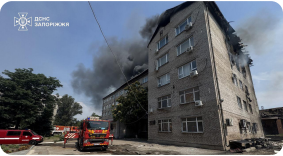 A building being extinguished by a fire truck after a Russian attack.