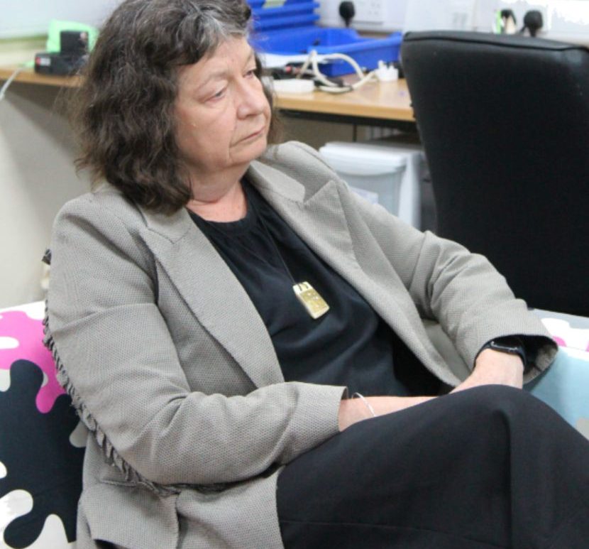 Wendy larner sat on a sofa.