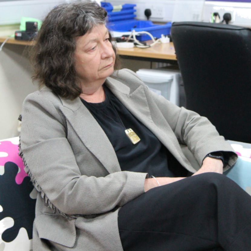 Wendy larner sat on a sofa.