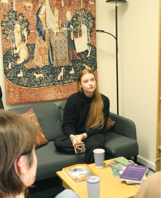 Daisy Dixon sat on a sofa.