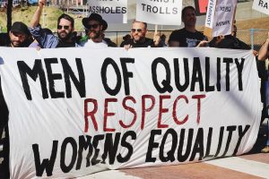 Image of men protesting: 'Men of Quality Respect Womens equality'. In this article the image can relate to the Sarah Everard case