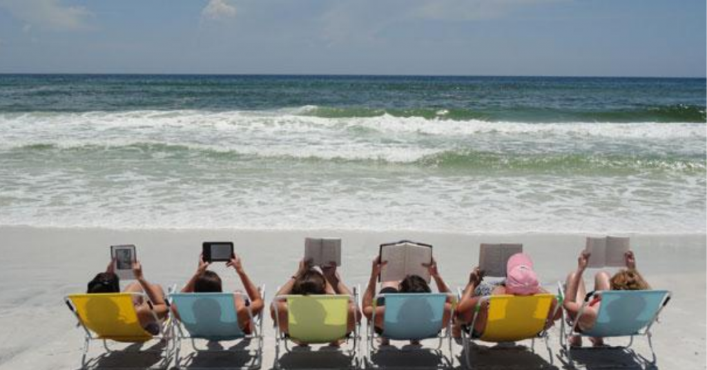 Picture of people reading at the beach.