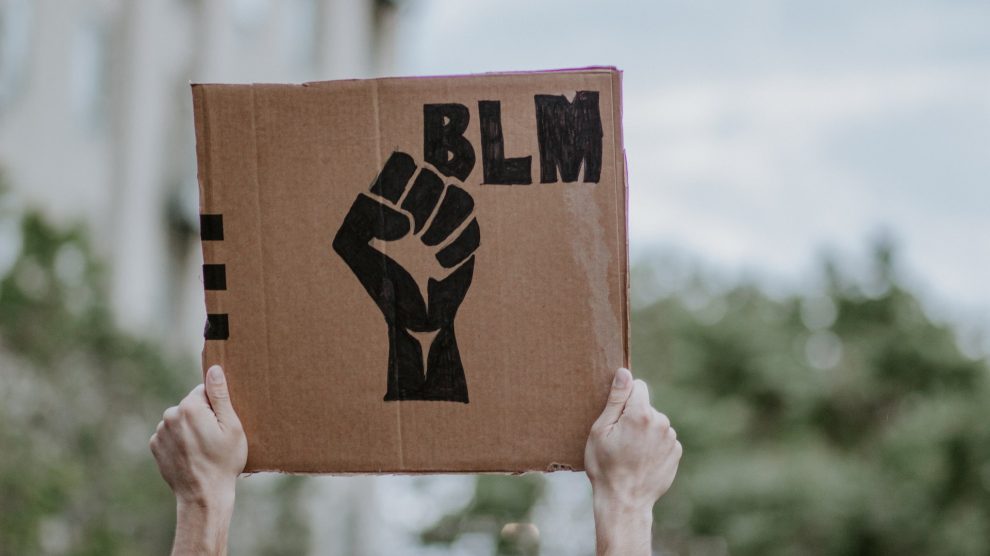 Poster with a raised fist next to the letters "BLM"