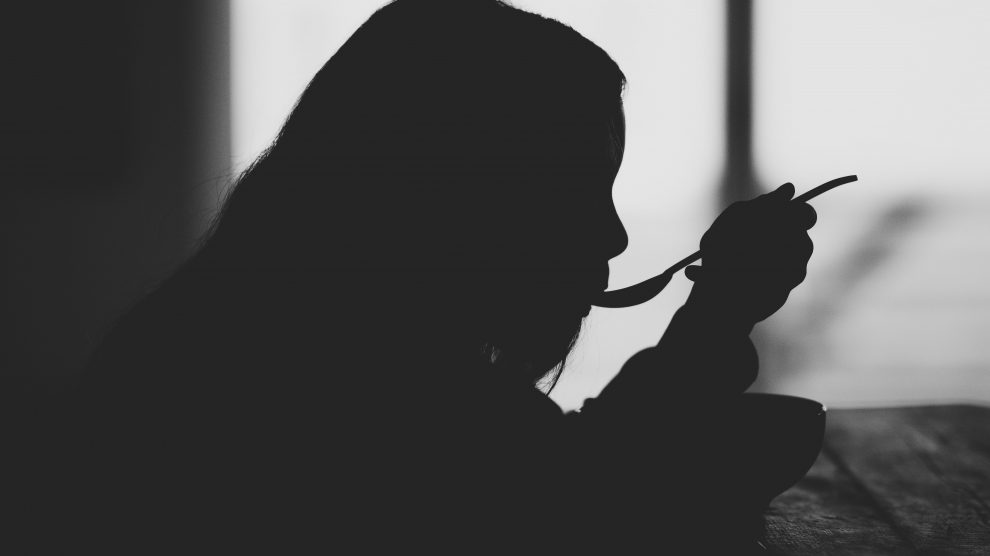 Black & White Image of a Girl Eating Alone. Image by Annie Spratt on Unsplash