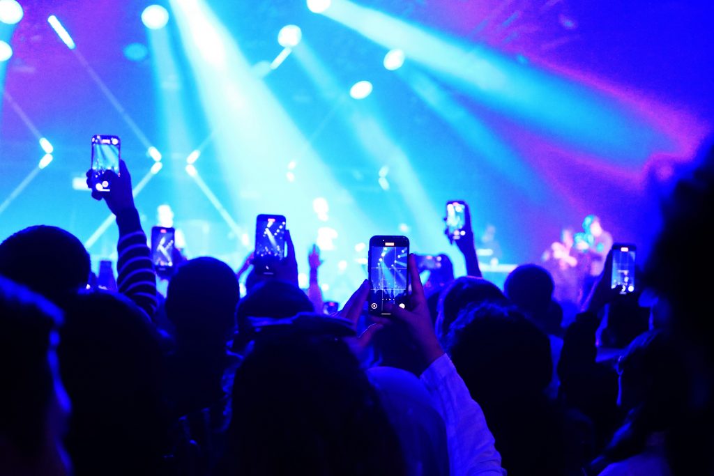 phones at a concert in a crowd