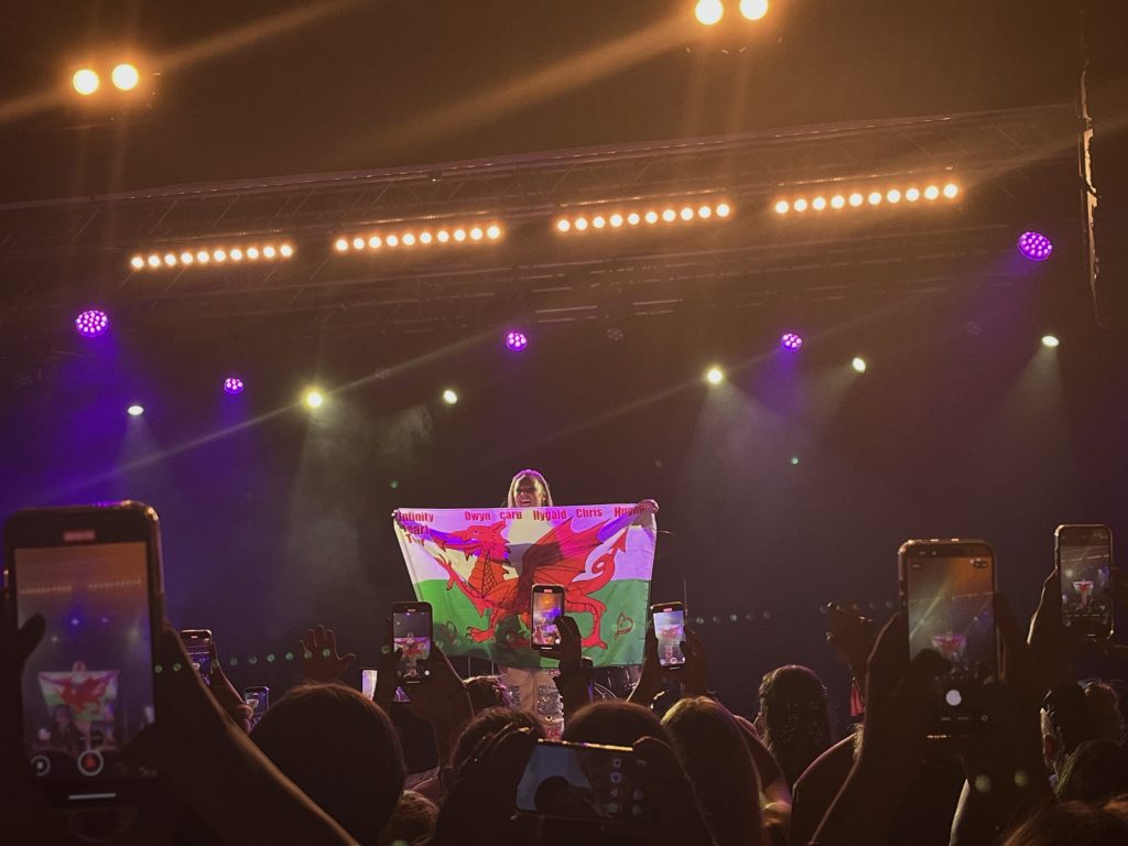 JoJo Siwa with Welsh flag on stage at Tramshed