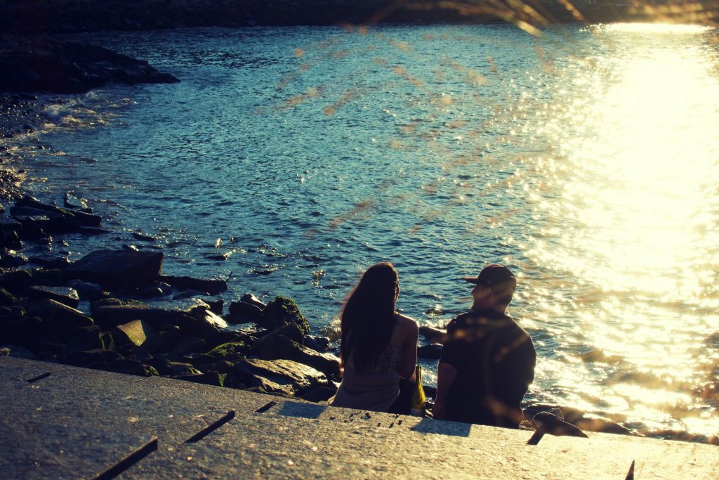 couple sitting by the water