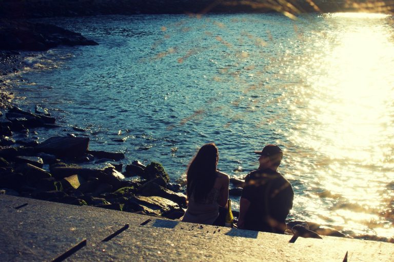 couple sitting by the water