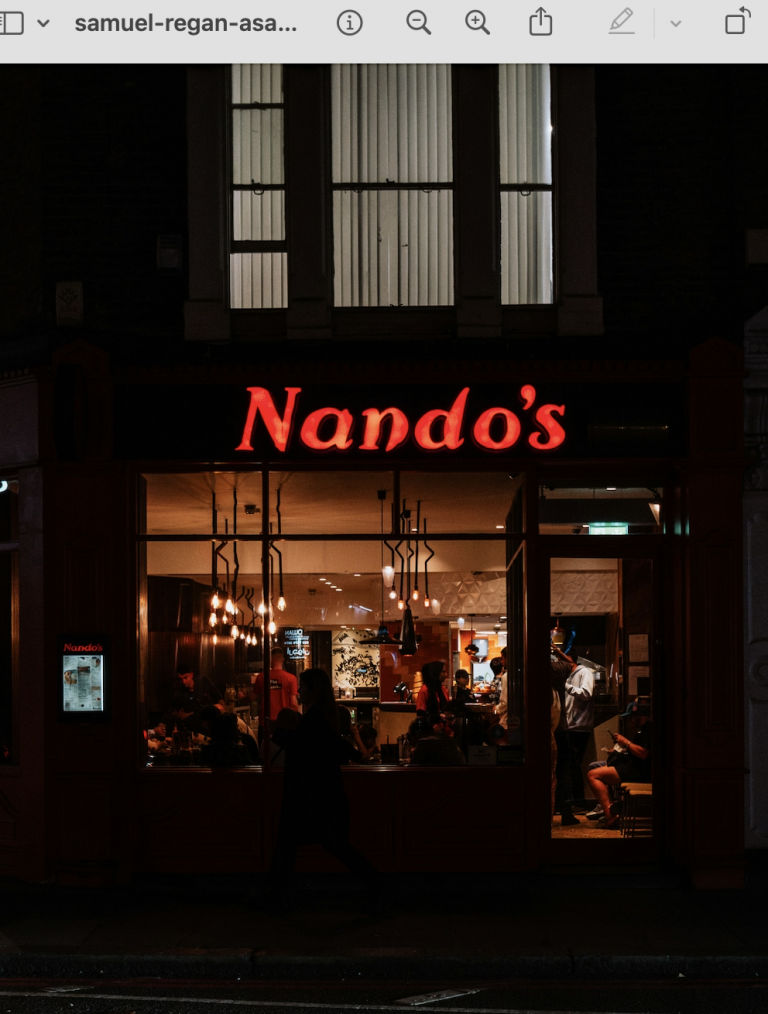 Nando's shopfront and neon sign at night